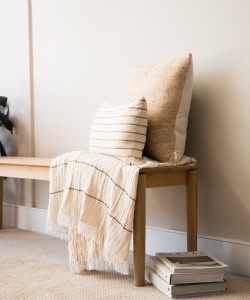 wood bench with cushions on top